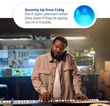 Craig playing keyboard in his workshop with security monitoring in the background