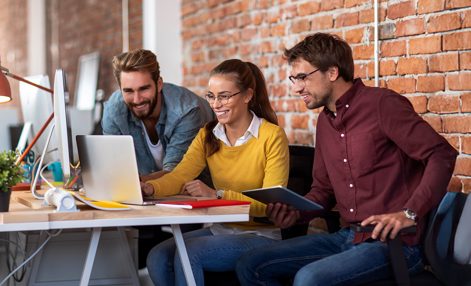 A group of business employees gathered on a computer connected to AT&T Business Internet services 