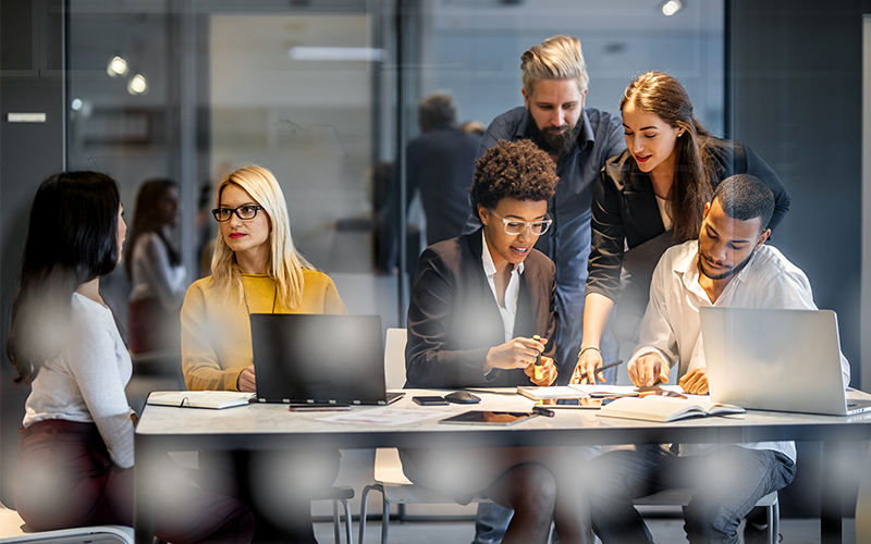 A group of business employees on computers utilizing AT&T Business Dedicated Internet services to stay connected